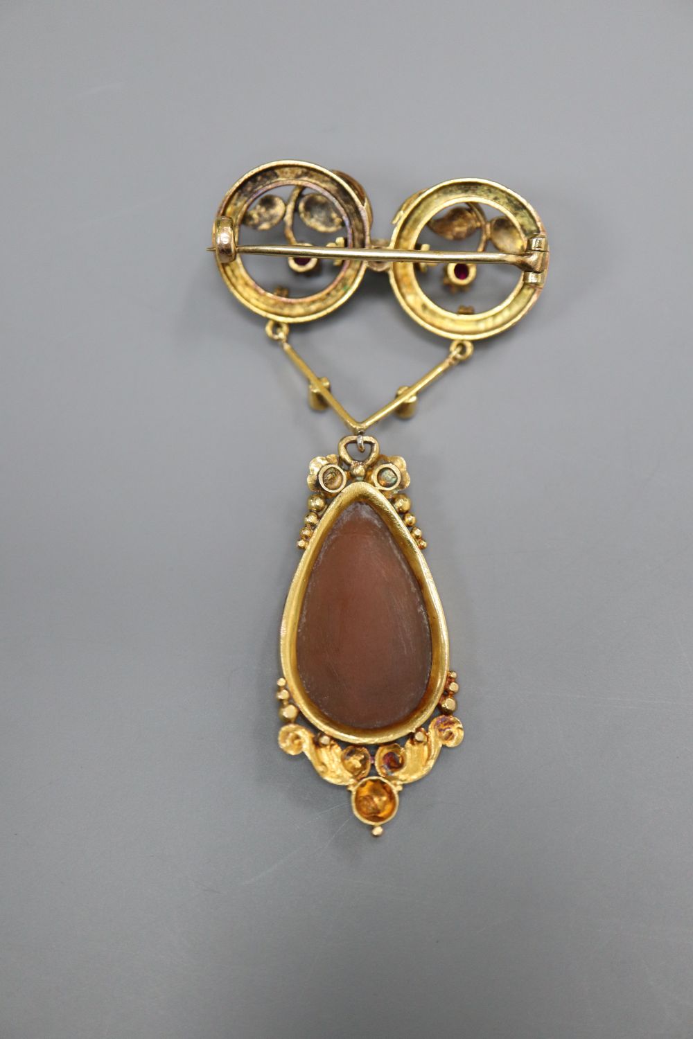 A Victorian yellow metal, ruby, rose cut diamond and carved cameo shell set drop pendant brooch, 61mm, gross 8 grams,